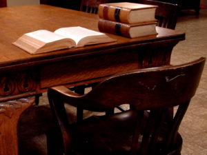 view of a table and chair with legal books and papers