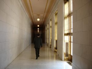 Wrongful death attorney walking down a court hall
