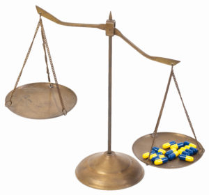 unbalanced golden brass scales of justice by drugs