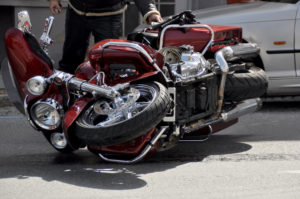 picture of a motorcycle accident with a red motorcycle