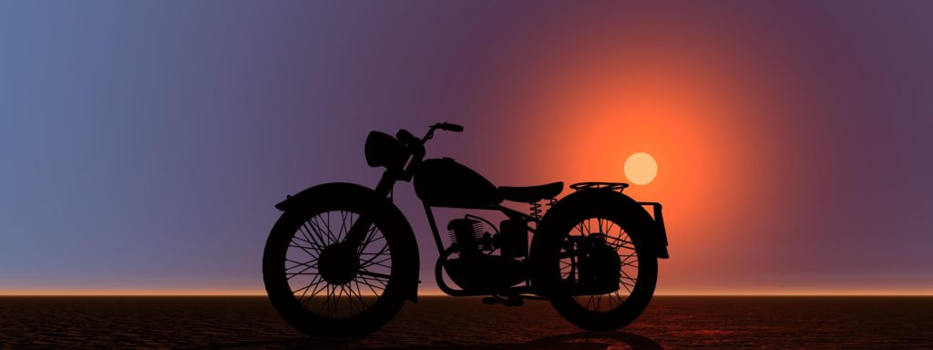 a motorcycle and a beautiful sunset in the background